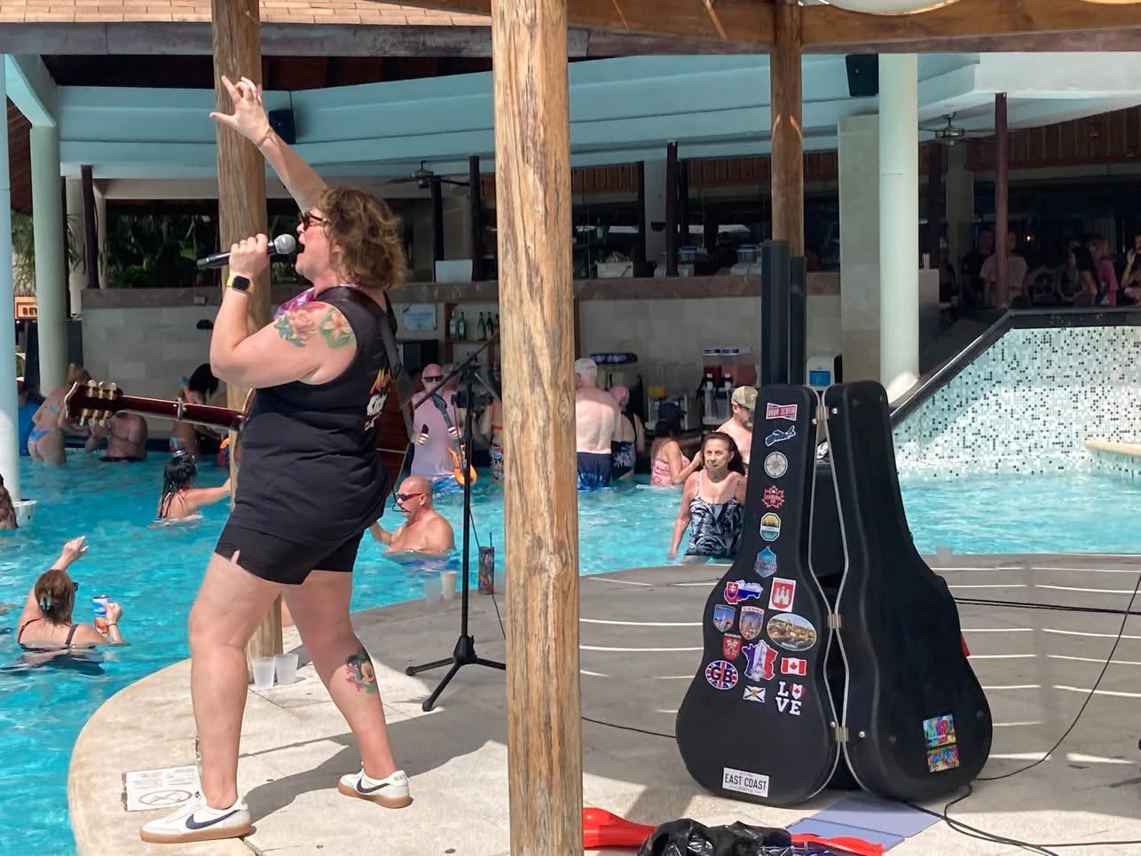 Lisa energizing an audience at a Caribbean resort pool