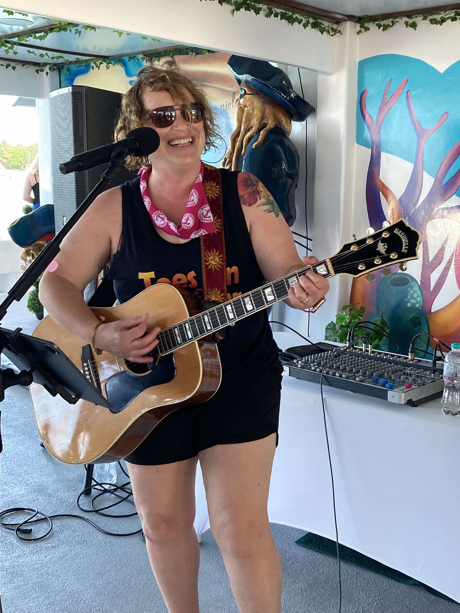 Lisa smiling while performing at a resort venue